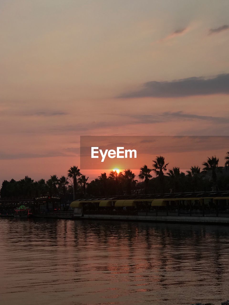 SCENIC VIEW OF LAKE AGAINST ORANGE SKY DURING SUNSET