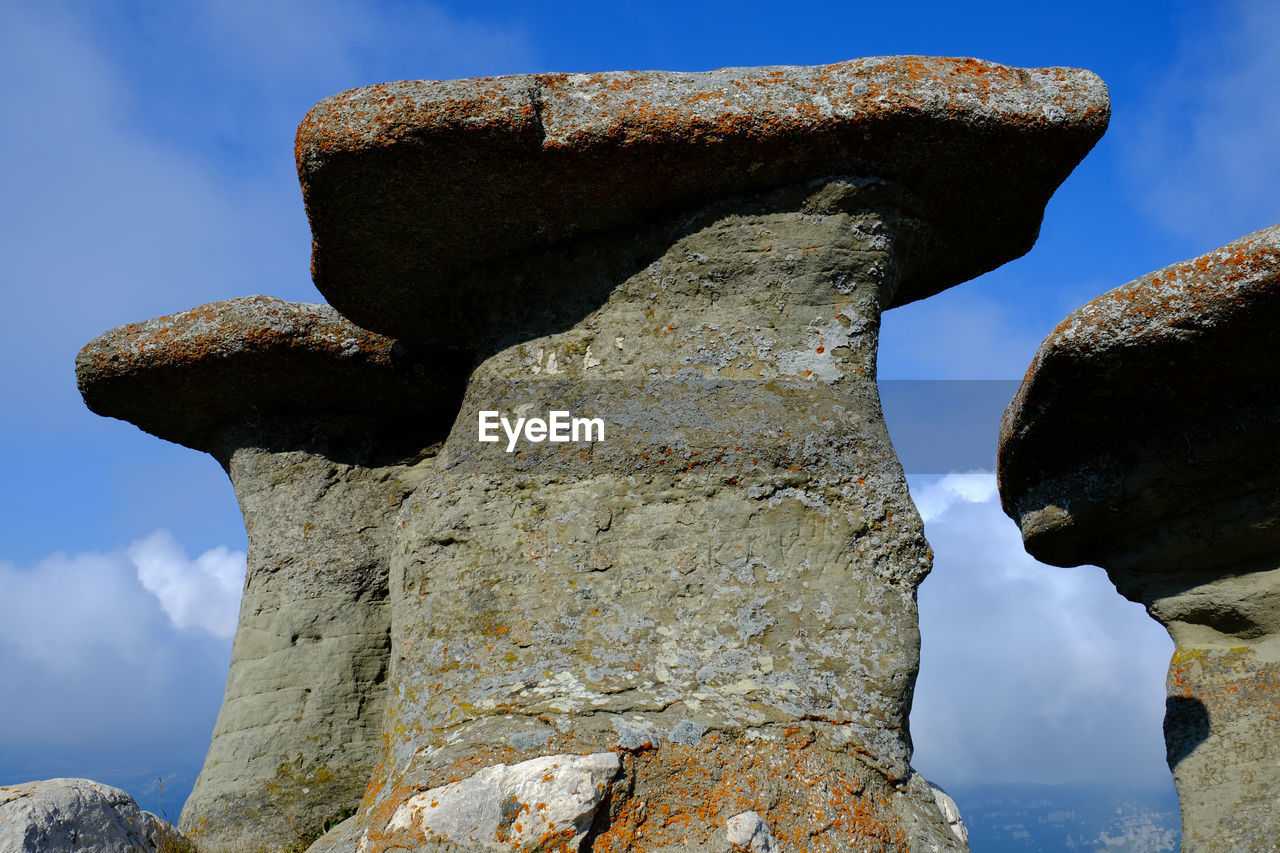 LOW ANGLE VIEW OF ROCK FORMATIONS AGAINST SKY