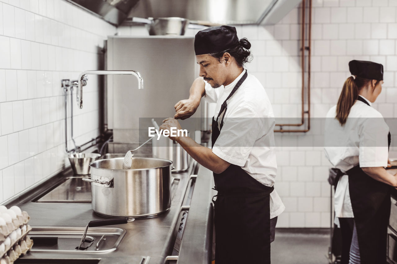 Chefs preparing food in commercial kitchen