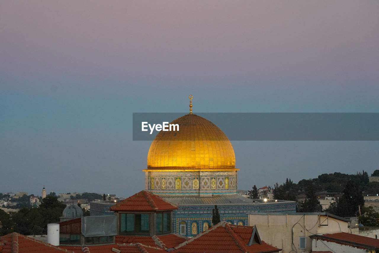Historical buildings against sky during sunset