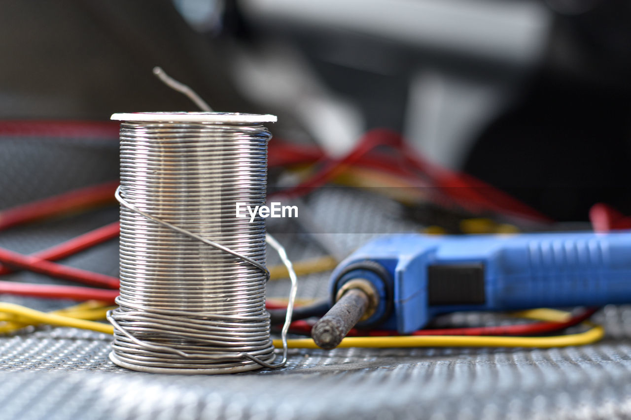 CLOSE-UP OF MACHINE PART ON METAL TABLE