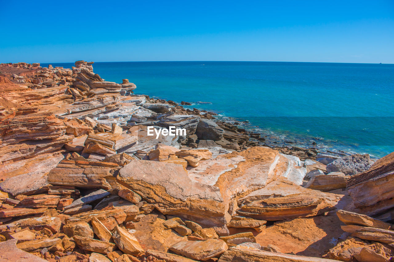 Scenic view of sea against clear blue sky