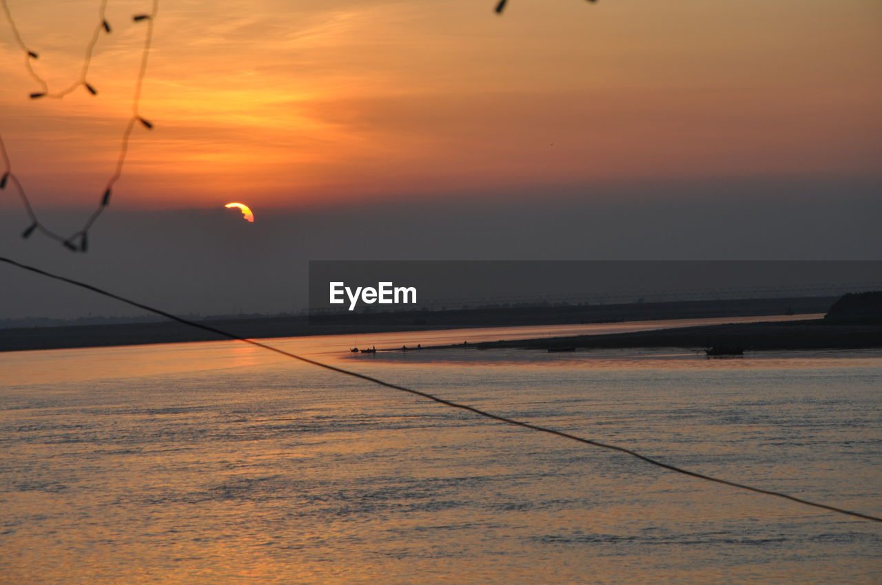 SCENIC VIEW OF SUNSET OVER LANDSCAPE AGAINST SKY