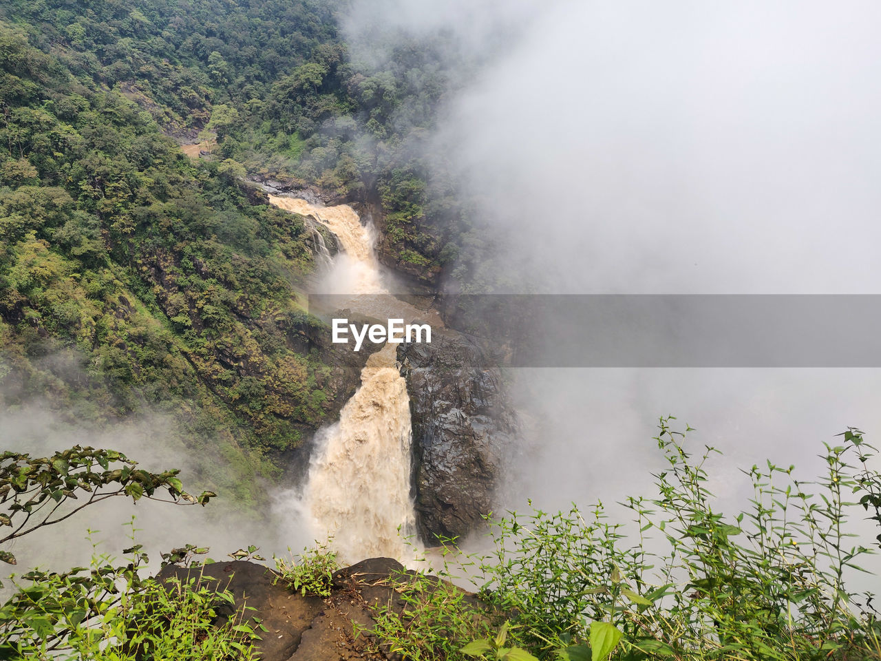 environment, fog, beauty in nature, scenics - nature, nature, water, plant, waterfall, landscape, water feature, land, travel, tree, travel destinations, mountain, no people, tourism, outdoors, non-urban scene, body of water, rock, social issues, geology, forest, cloud, sky, motion, day