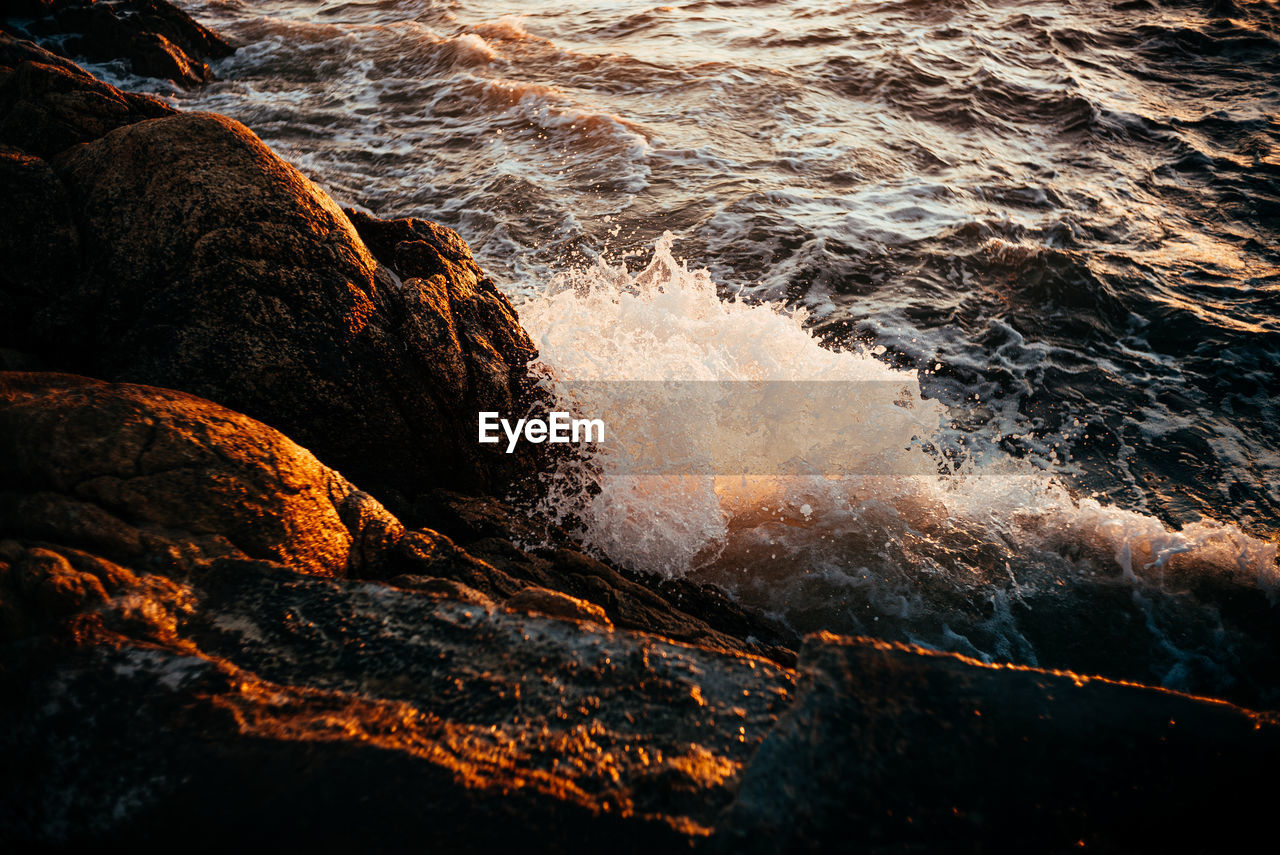 Waves splashing on rock formation 