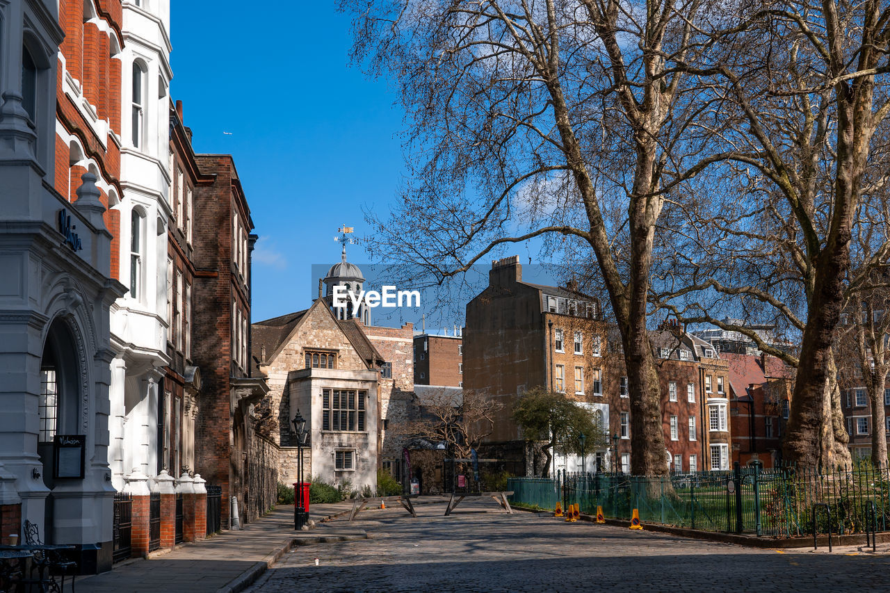 Street amidst buildings against sky in city