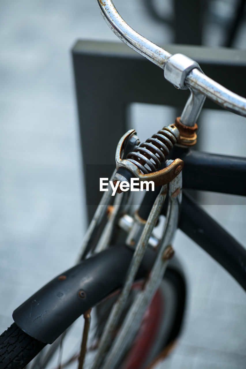 Close-up of bicycle parked on metal