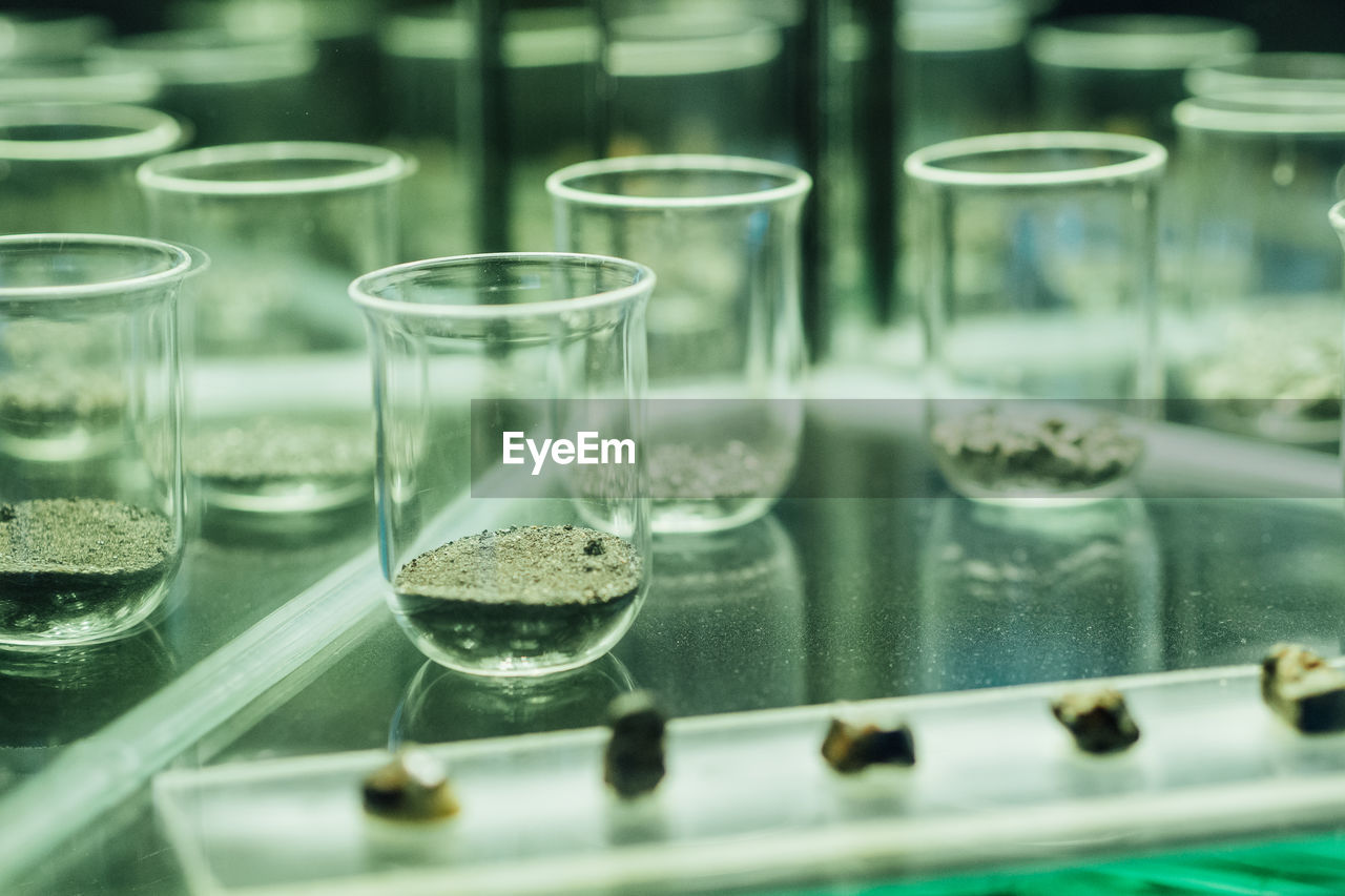 Minerals in laboratory glassware on table