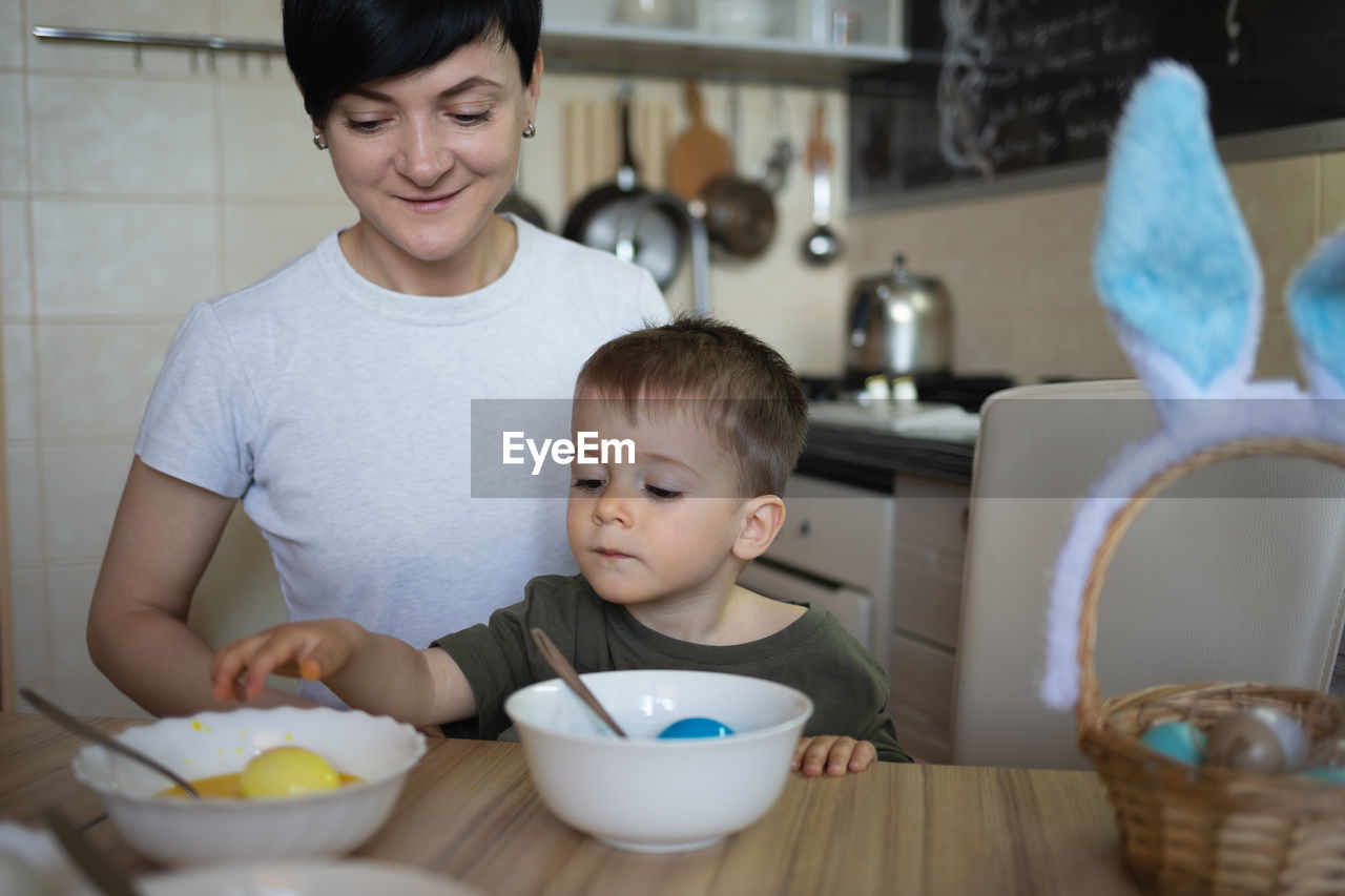 portrait of cute girl sitting on table at home