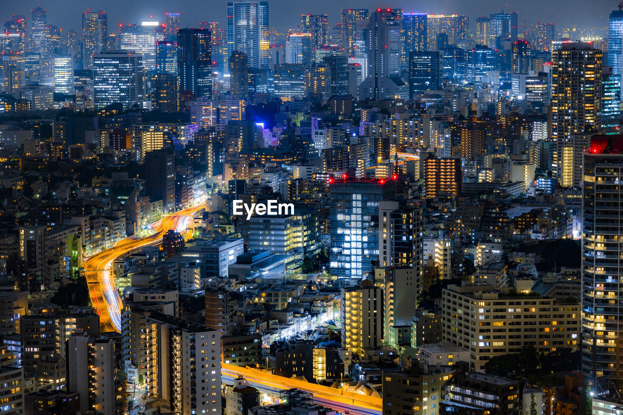 Aerial view of illuminated city buildings at night