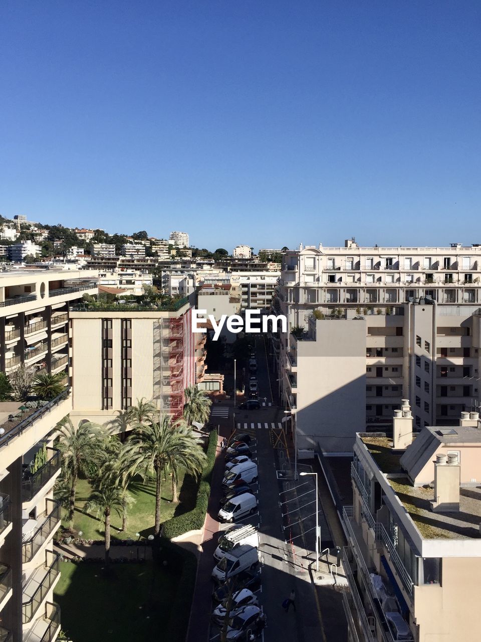 High angle view of buildings against clear blue sky