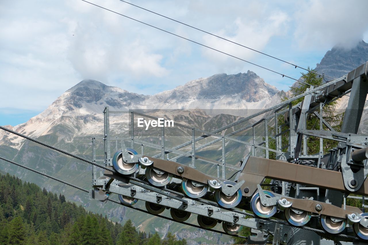 Cable car on mountain against sky