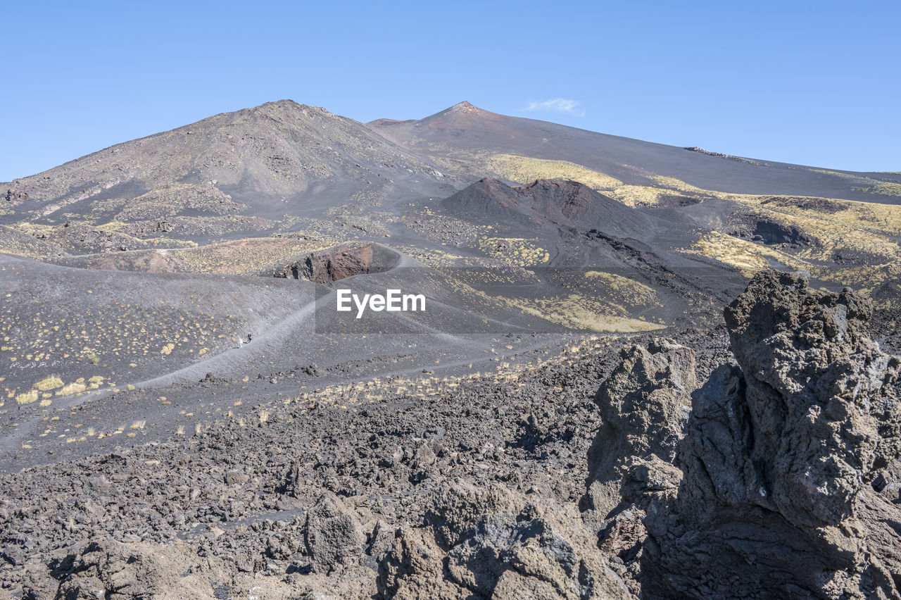 The etna volcano with its craters, lava and lunar landscape