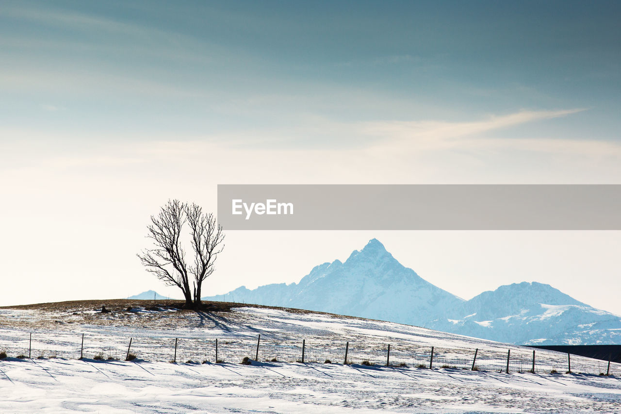 Scenic view of snow covered mountains against sky