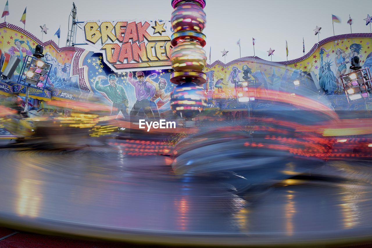 REFLECTION OF CAROUSEL IN WATER