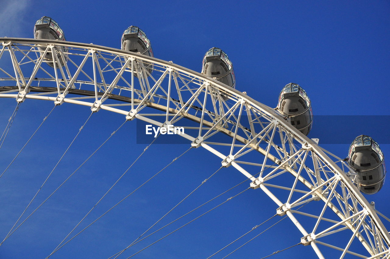 Low angle view of millennium wheel against clear blue sky