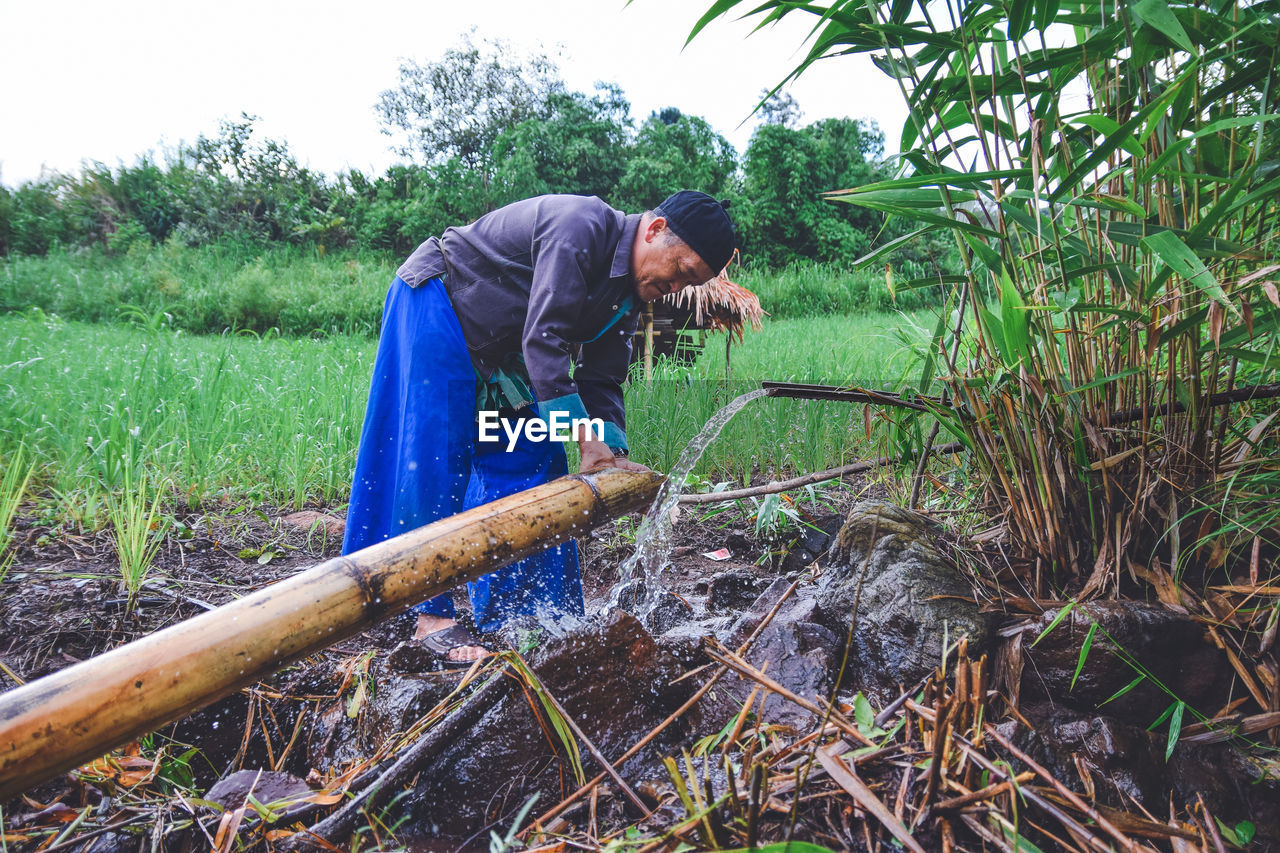 MAN WORKING ON FIELD