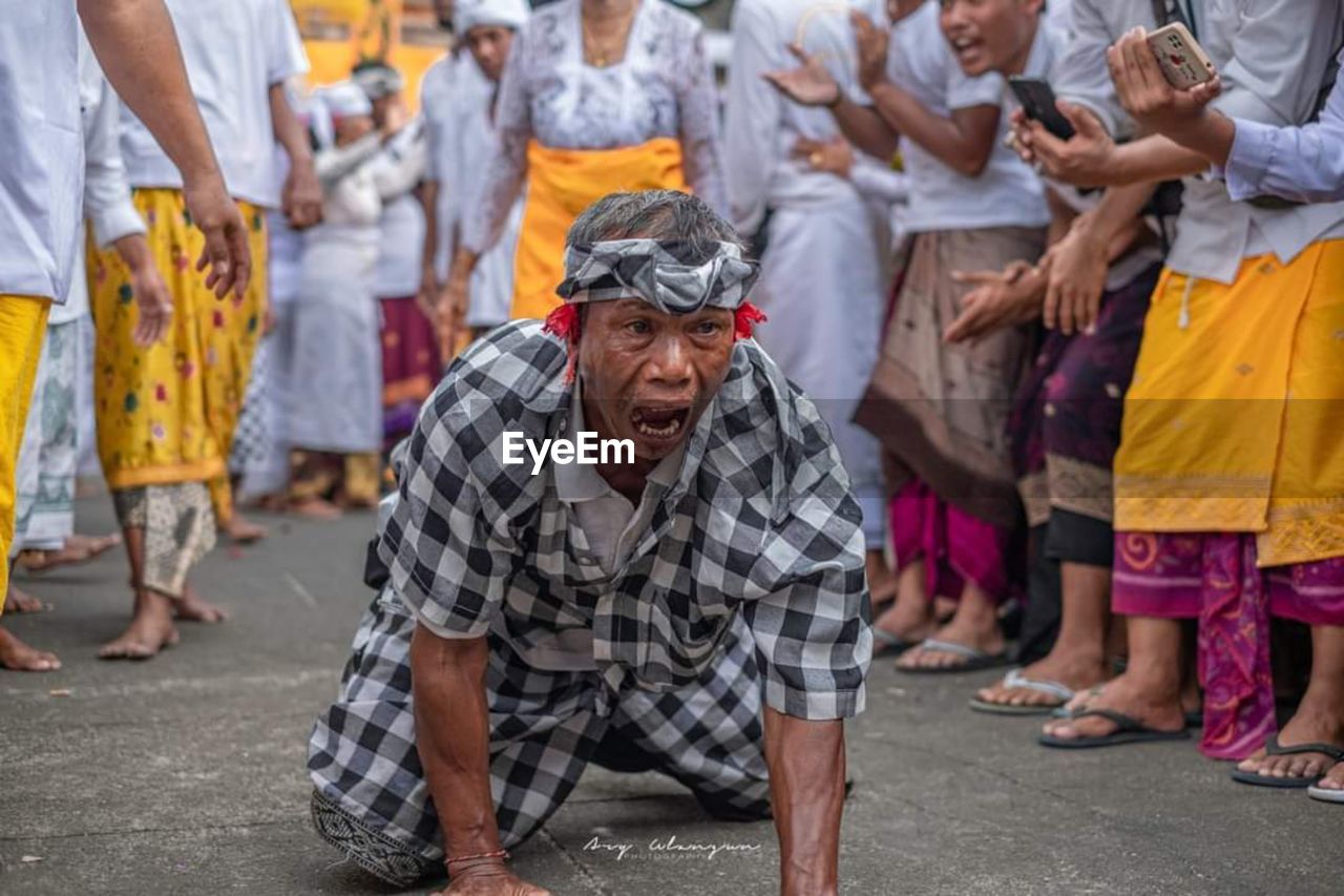 group of people, men, adult, street, crowd, city, traditional clothing, large group of people, tradition, women, person, clothing, day, celebration, festival, poverty, lifestyles, arts culture and entertainment, outdoors, dancing, traditional festival, togetherness