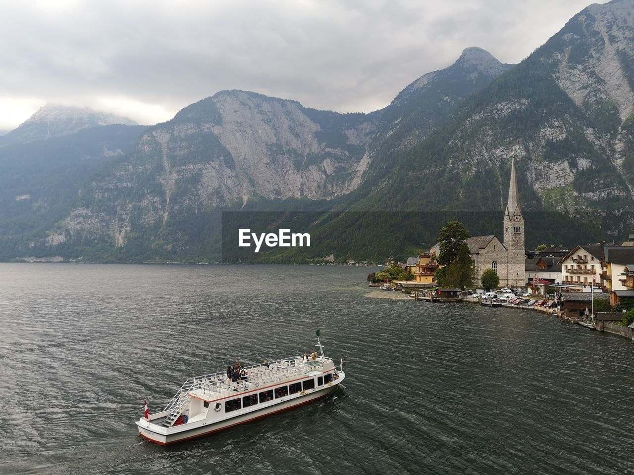 VIEW OF BOATS IN SEA AGAINST MOUNTAINS