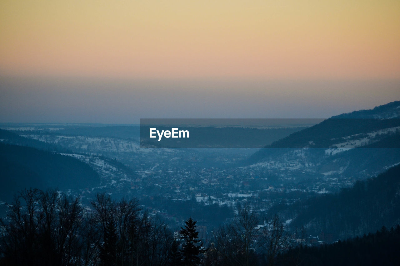 AERIAL VIEW OF LANDSCAPE AGAINST SKY DURING WINTER