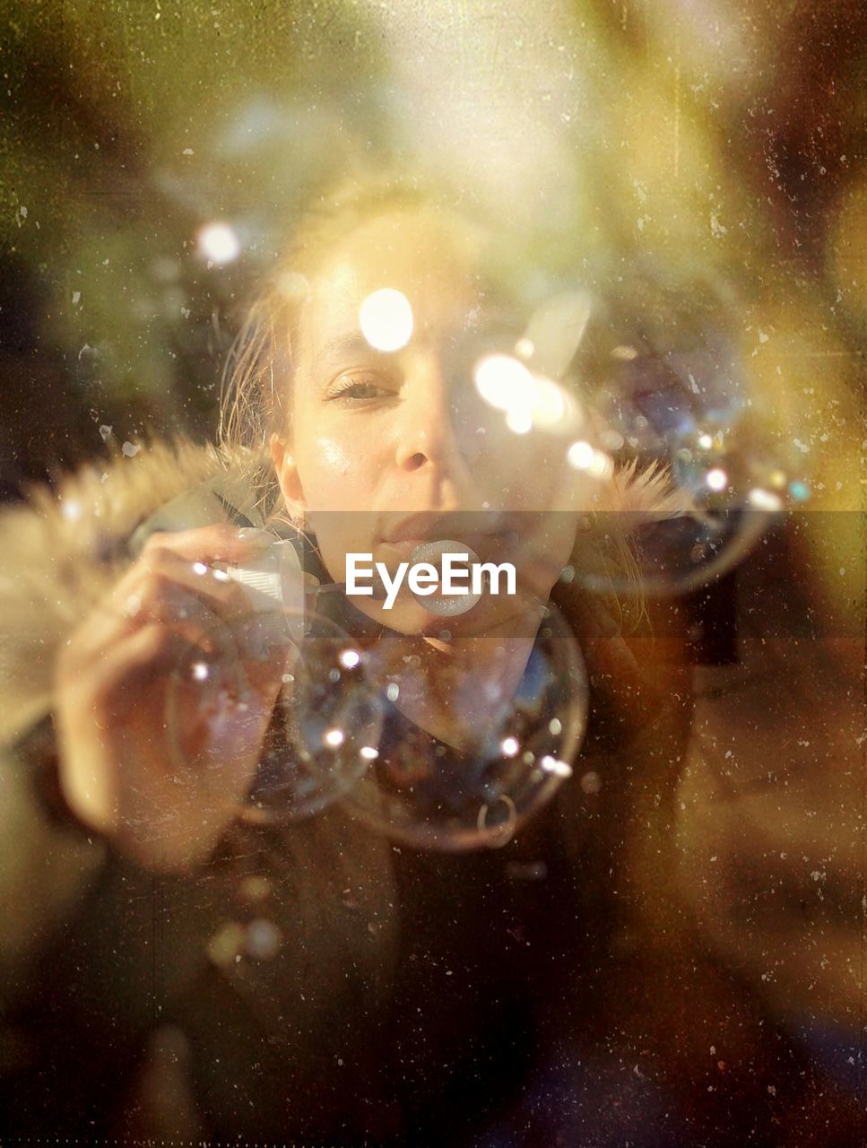 Portrait of woman holding bubbles