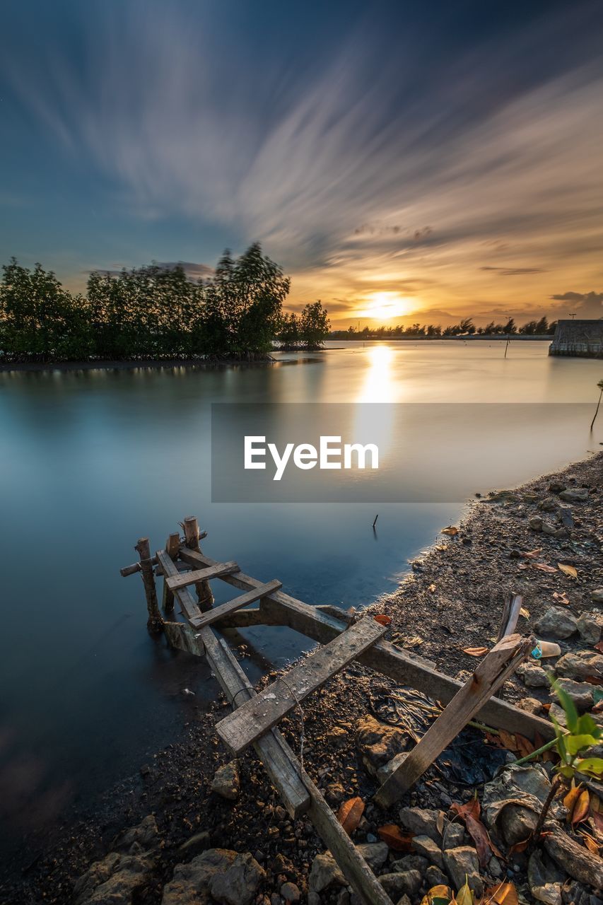 SCENIC VIEW OF LAKE AT SUNSET