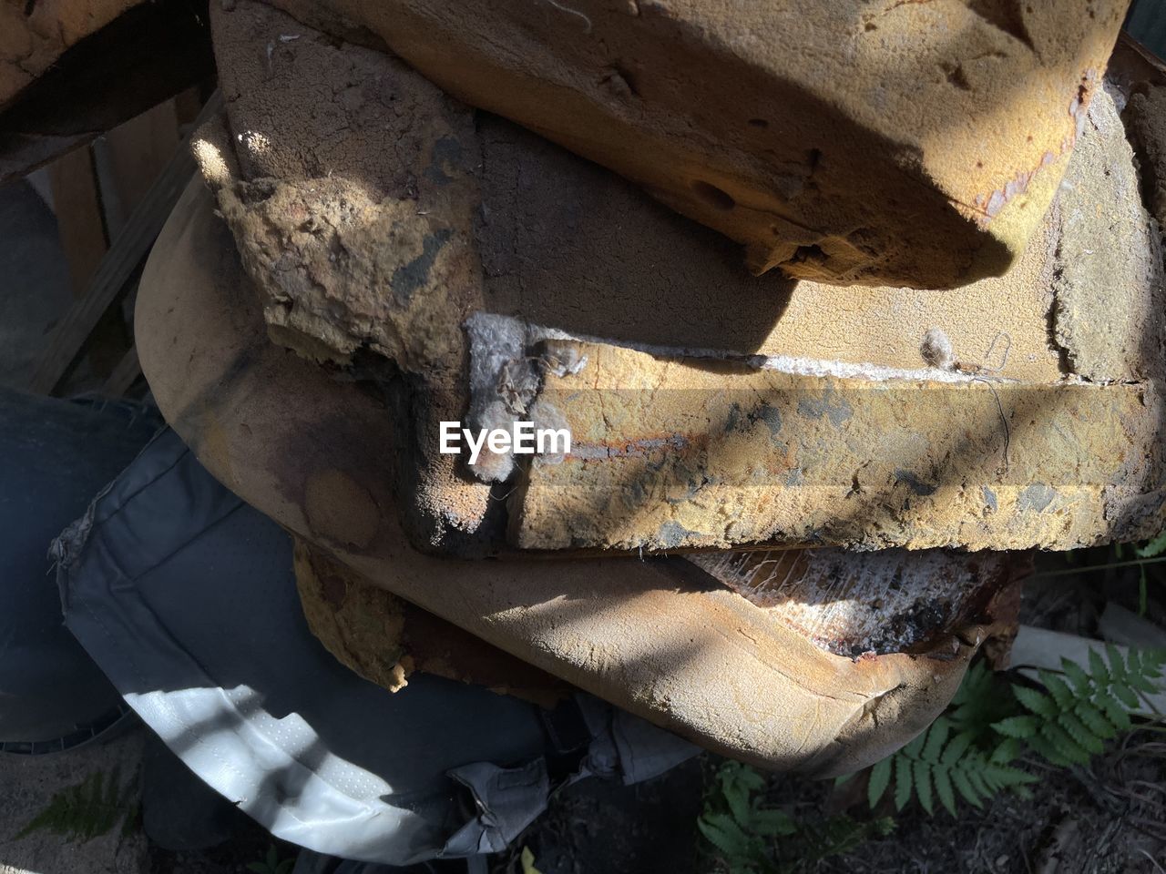 HIGH ANGLE VIEW OF OLD STACK OF LOGS IN WOODEN FLOOR