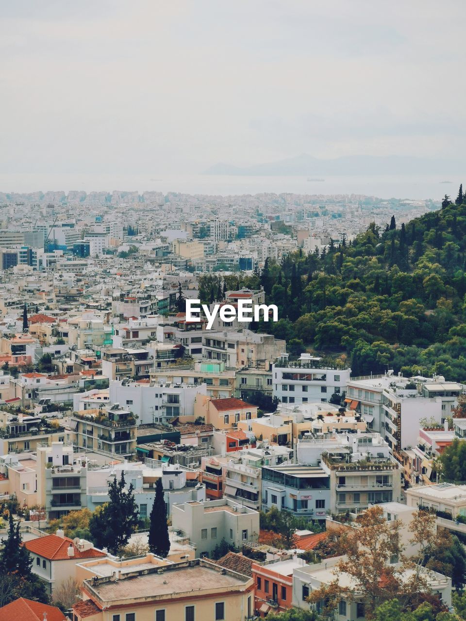 Photo of urban athens with hill in the corner 