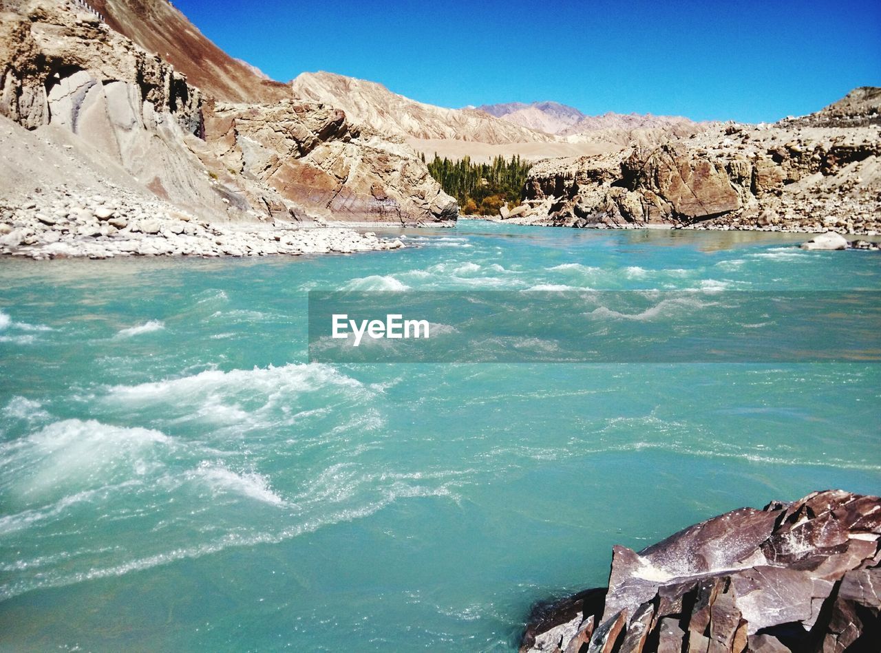 Scenic view of sea against blue sky