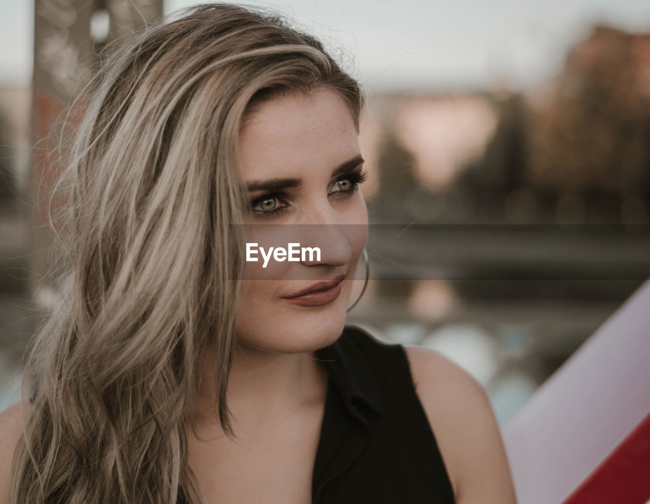 Close-up of beautiful young woman looking away