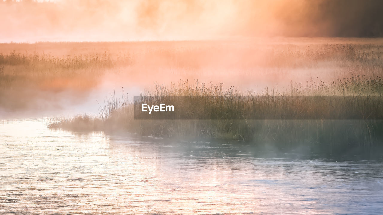 Scenic view of lake against sky during sunset