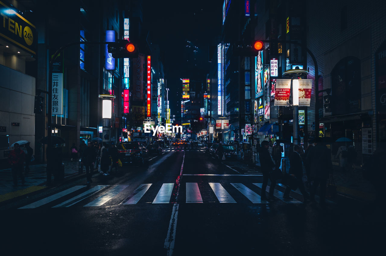 View of illuminated city street at night