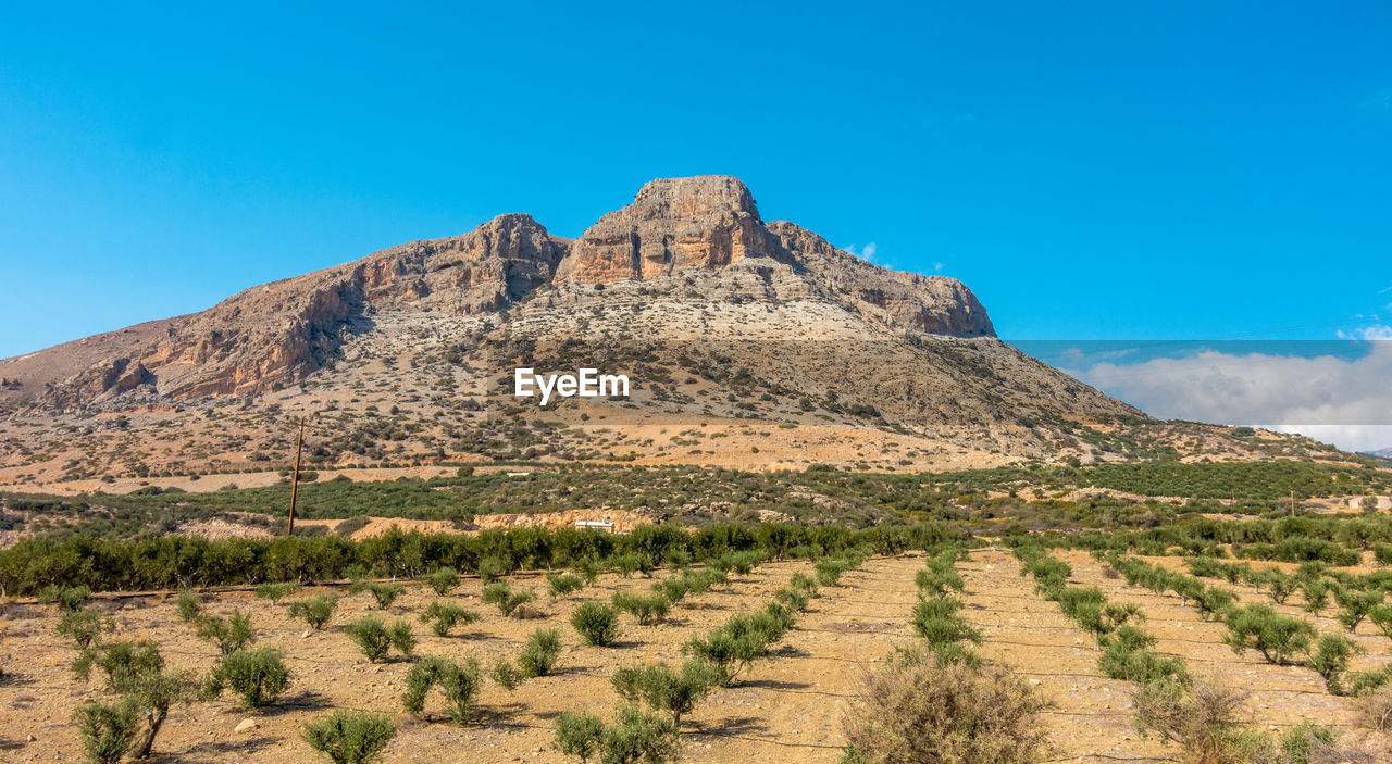 Scenic view of rocky mountains against clear blue sky near myrtos on the greek island crete