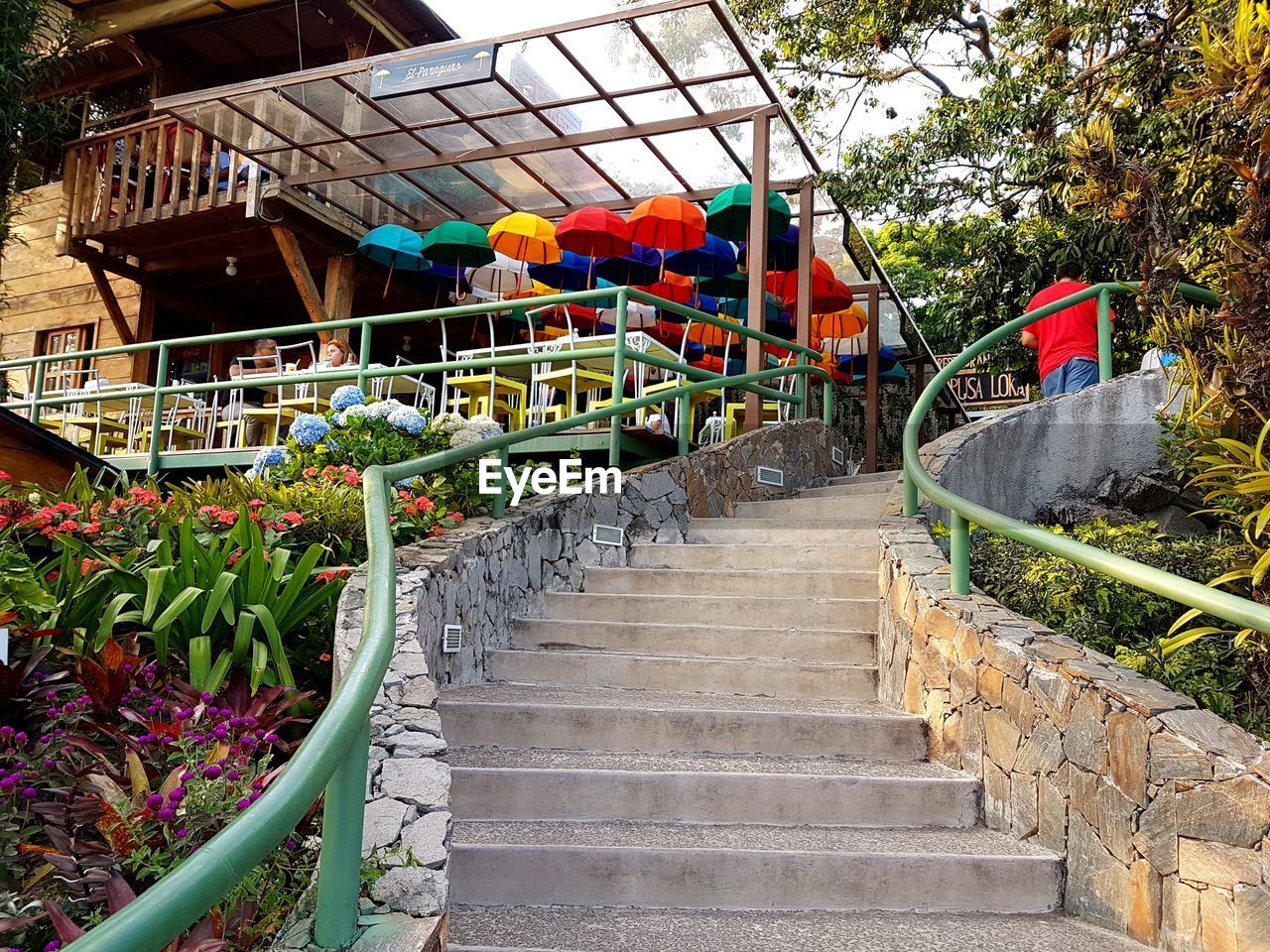 STEPS BY MULTI COLORED STAIRCASE AGAINST WALL