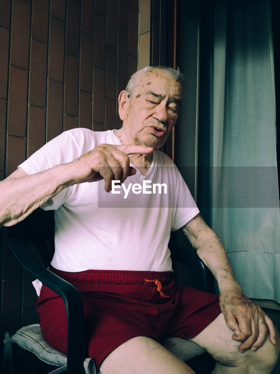 Senior man sitting in chair