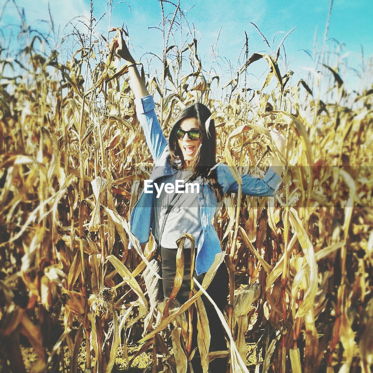 Portrait of happy woman in agricultural field