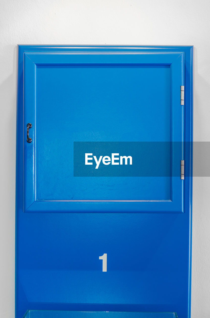 CLOSE-UP OF BLUE CLOSED DOOR