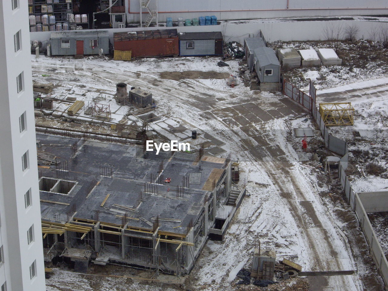 industry, high angle view, snow, architecture, winter, cold temperature, construction, construction industry, construction site, built structure, no people, transportation, day, transport, arena, incomplete, building exterior, development, outdoors, nature