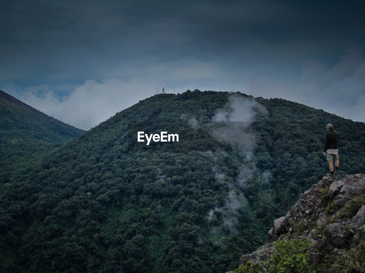 Man standing on mountain against sky