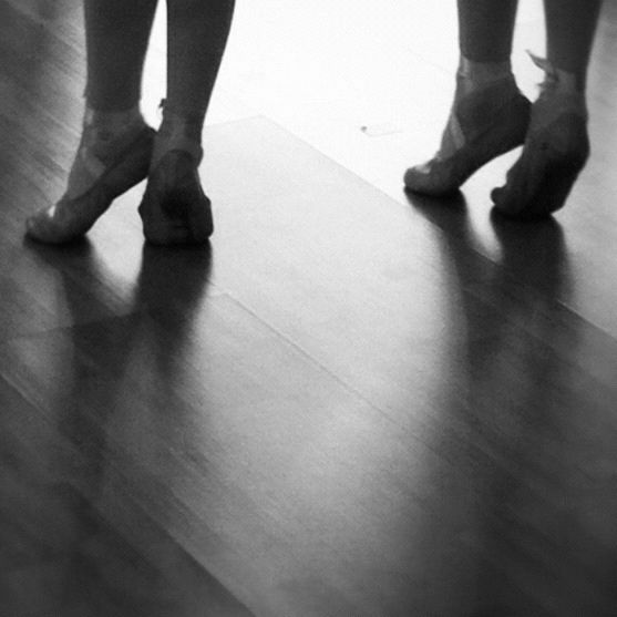 LOW SECTION OF WOMAN STANDING ON TILED FLOOR