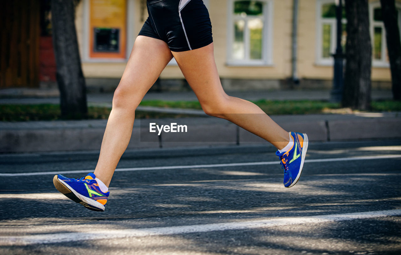 Female athlete running marathon race	
