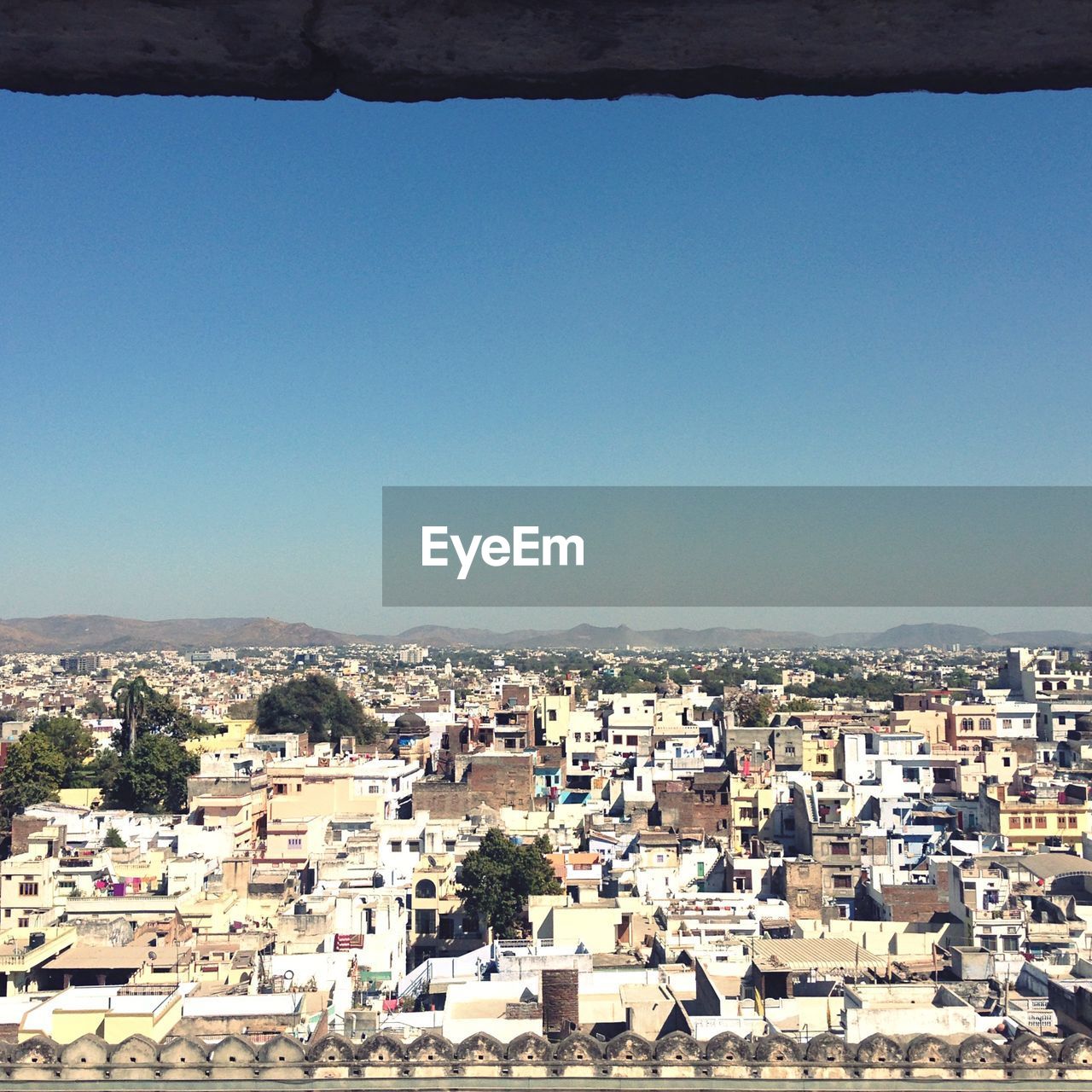 High angle view of houses against clear blue sky