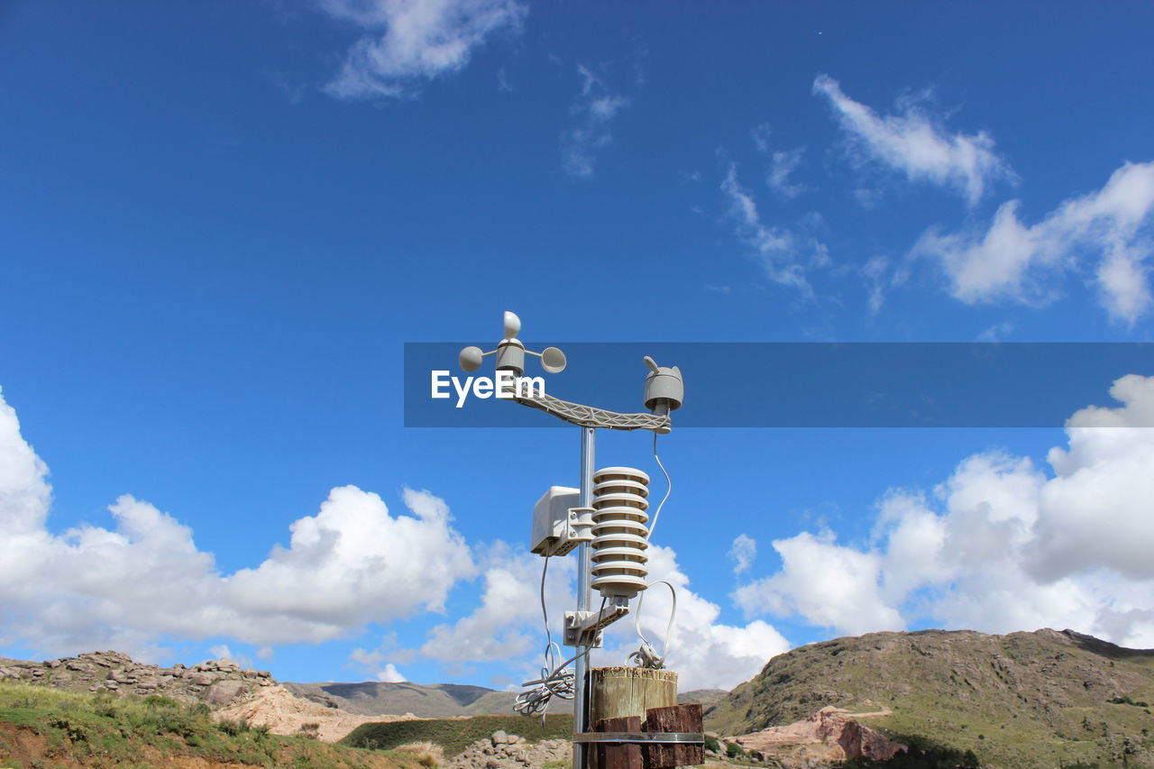 Low angle view of water station against blue sky