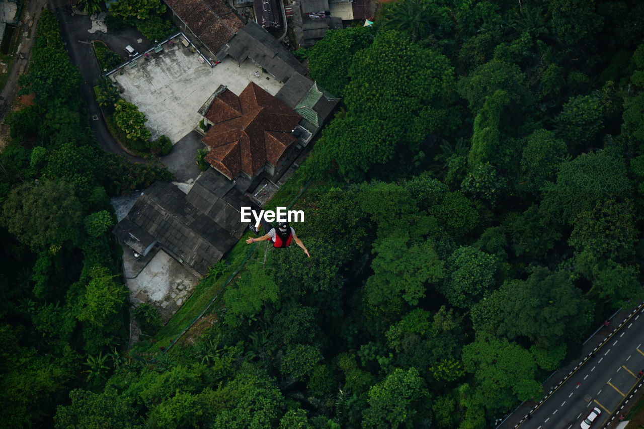 Aerial view of man base jumping over city