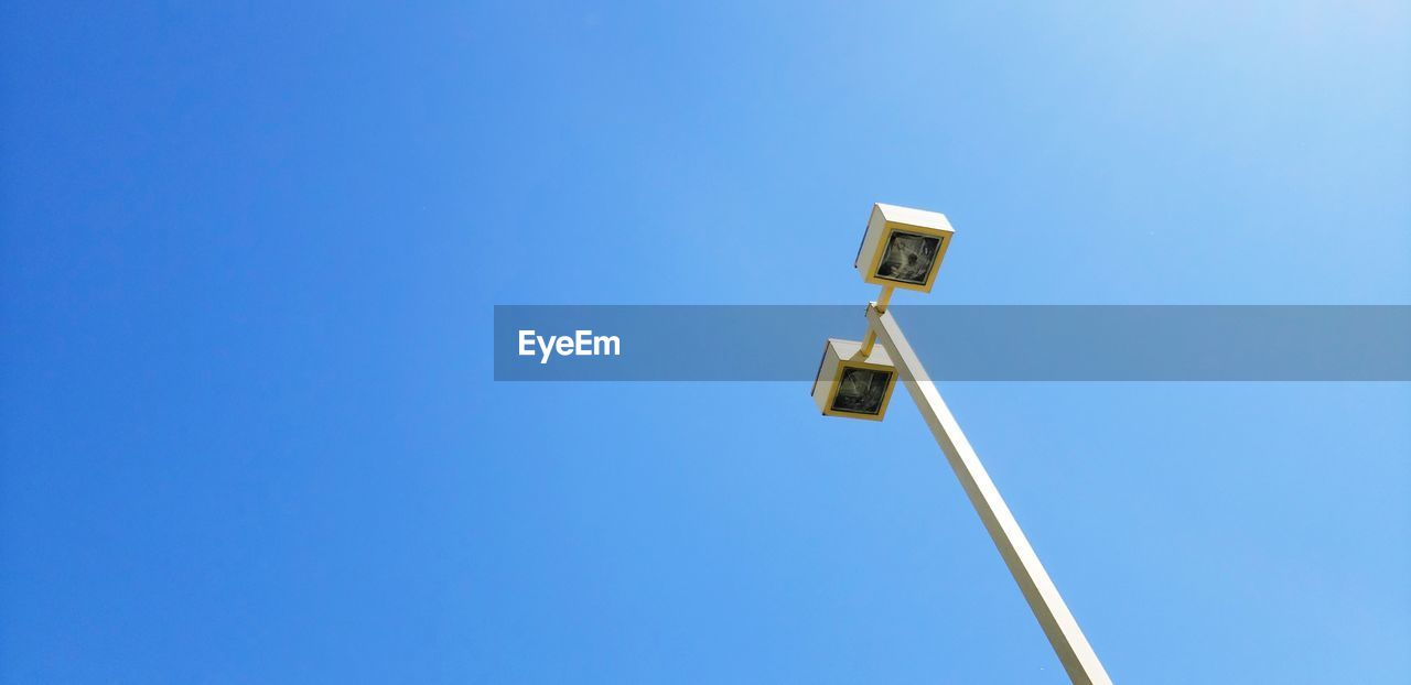 Low angle view of outdoor street  light fixture against clear blue sky