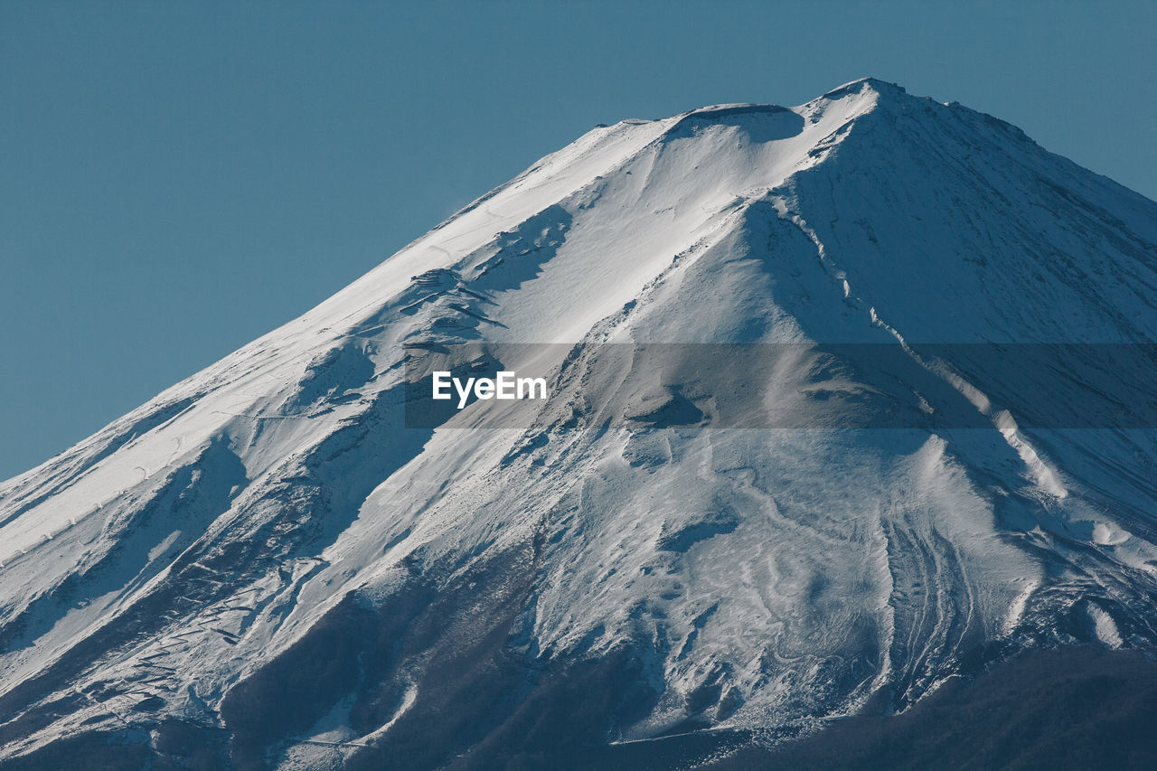 Scenic view of snowcapped mountains against clear sky