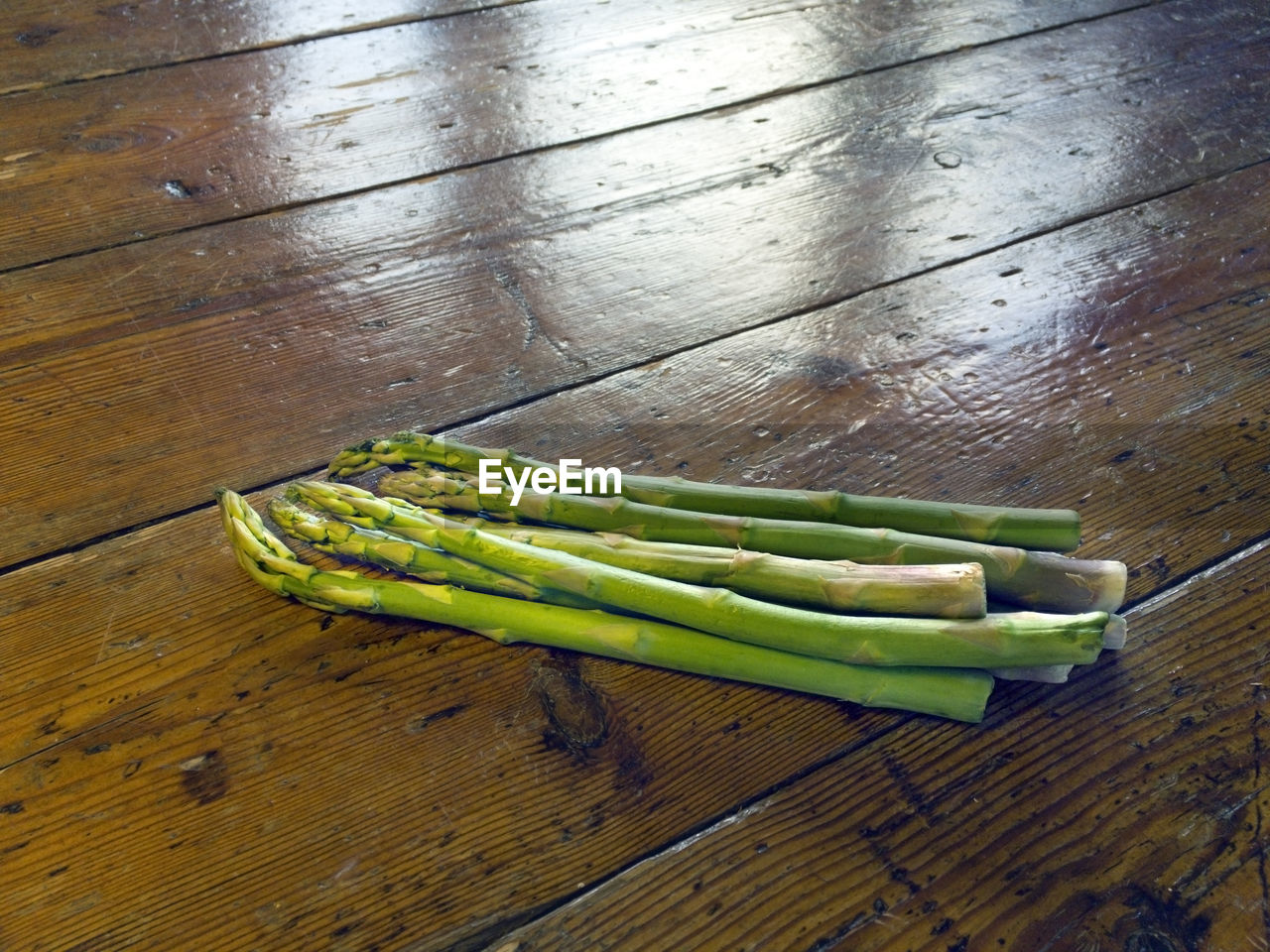 High angle view of asparagus on wooden table