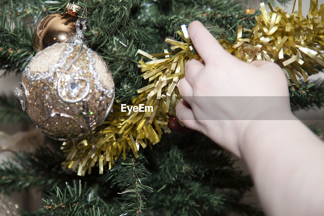 Close-up of hand holding tinsel