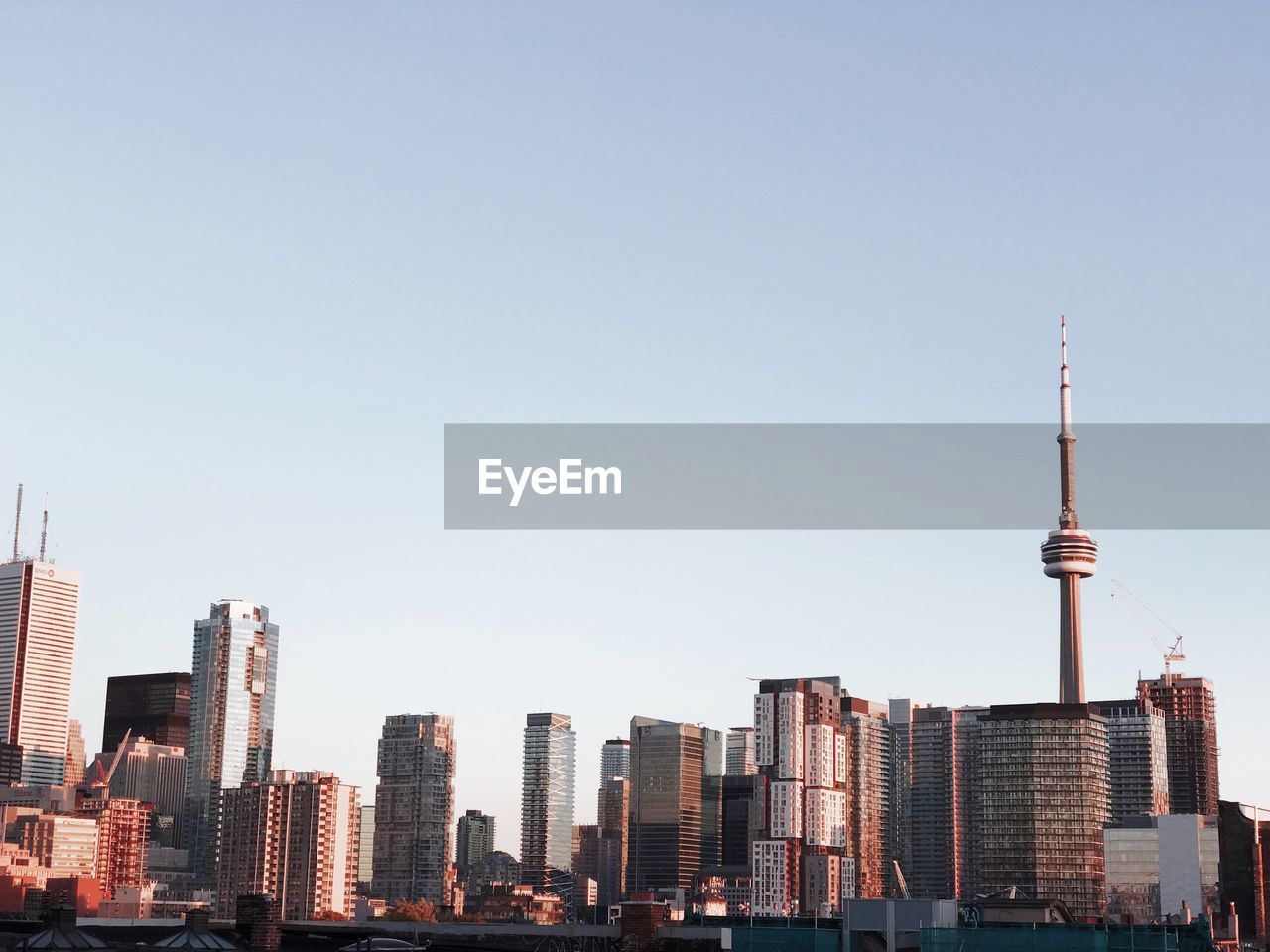 Modern buildings in city against clear sky