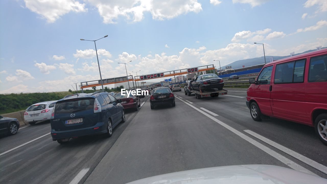 Cars moving on highway against sky